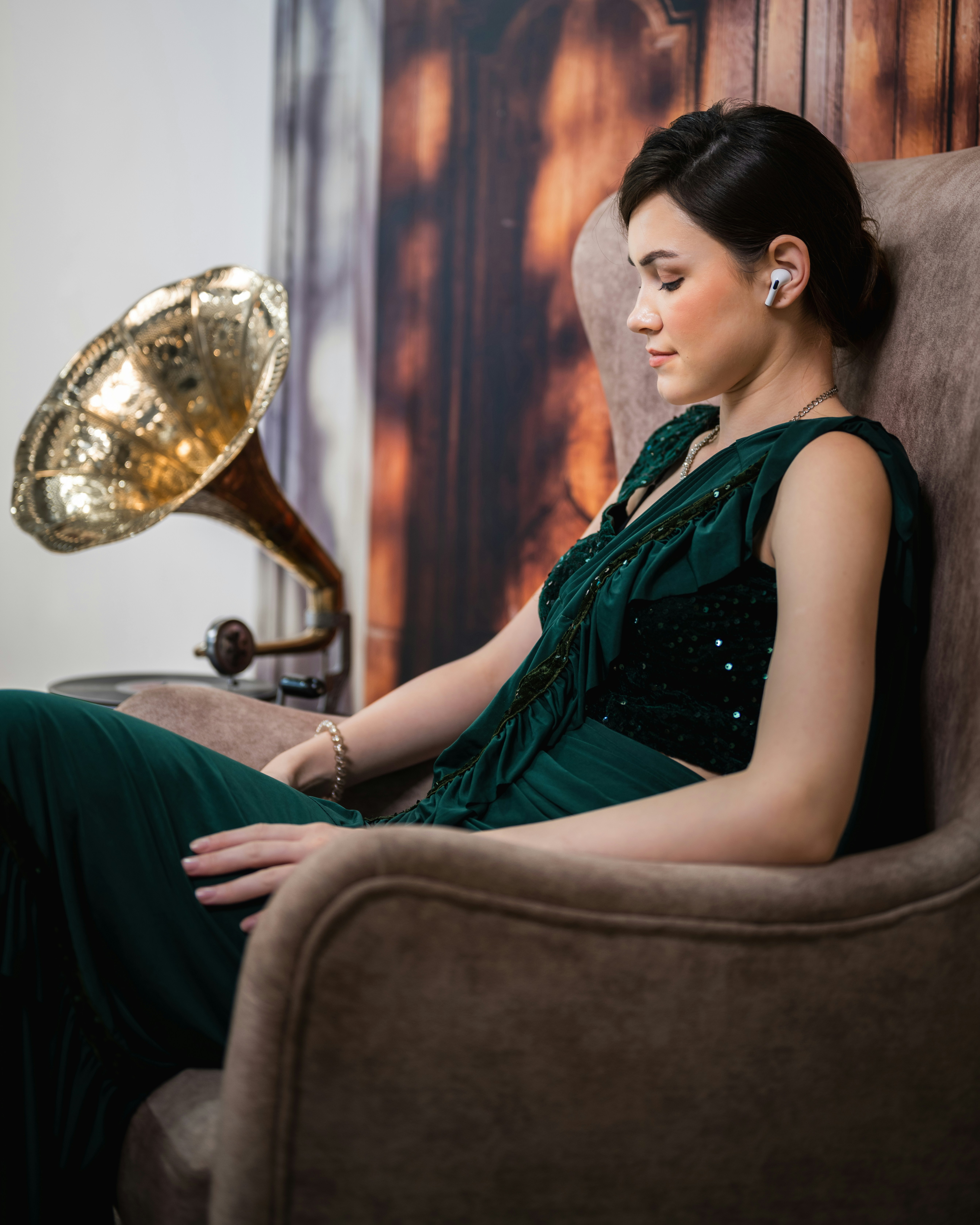 A woman in a green dress sitting in a chair
