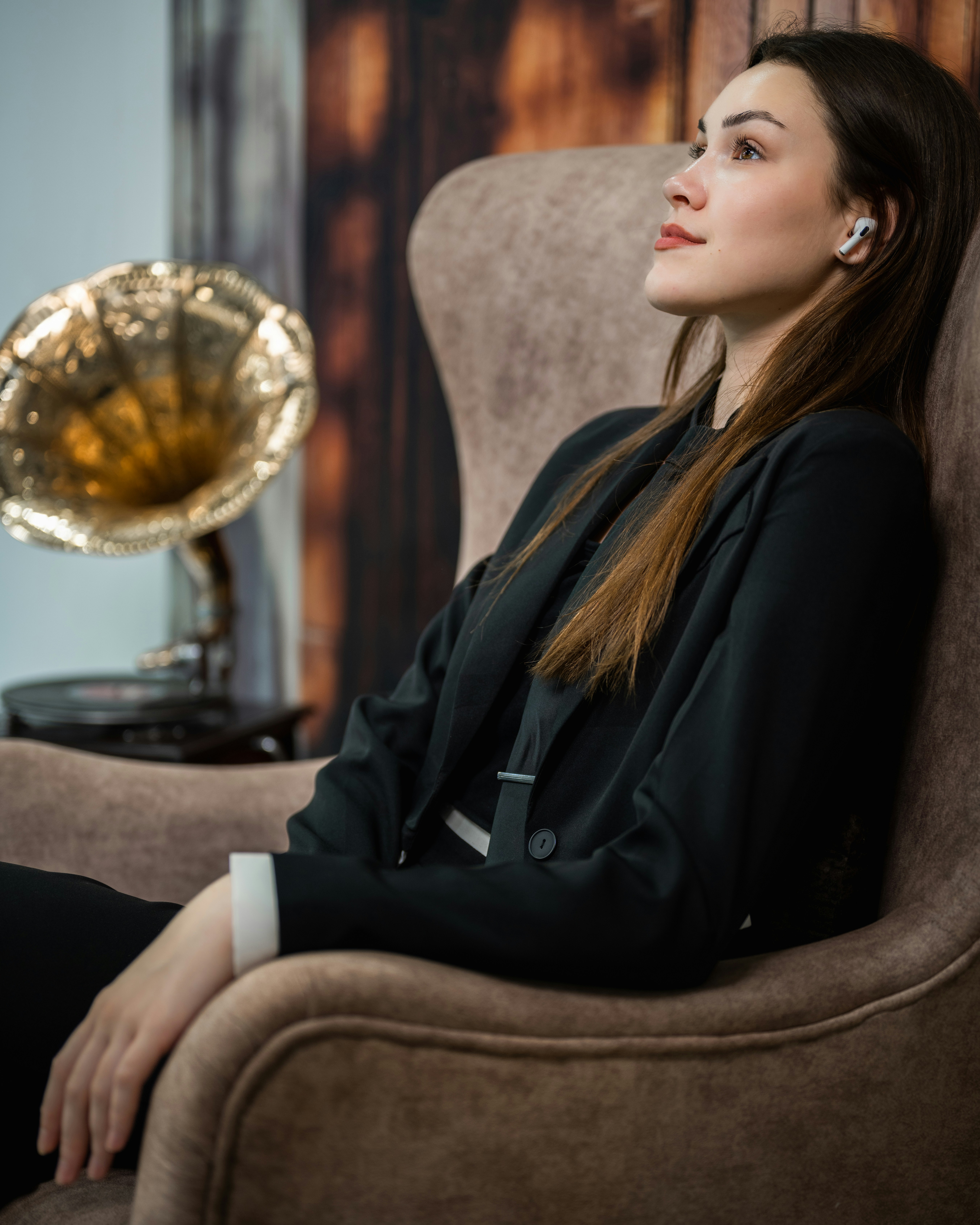A woman sitting in a chair looking up