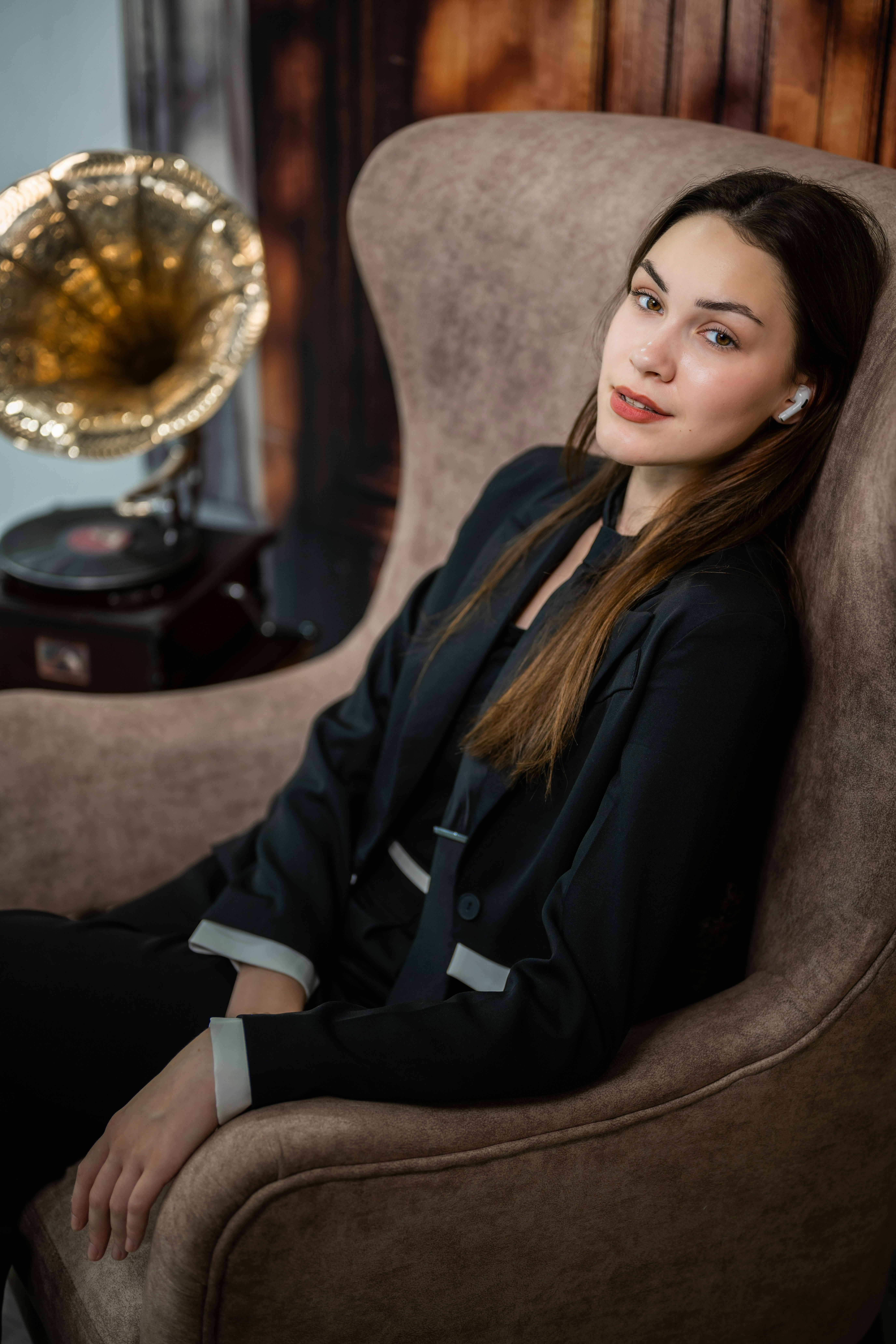 A woman sitting in a chair next to a lamp