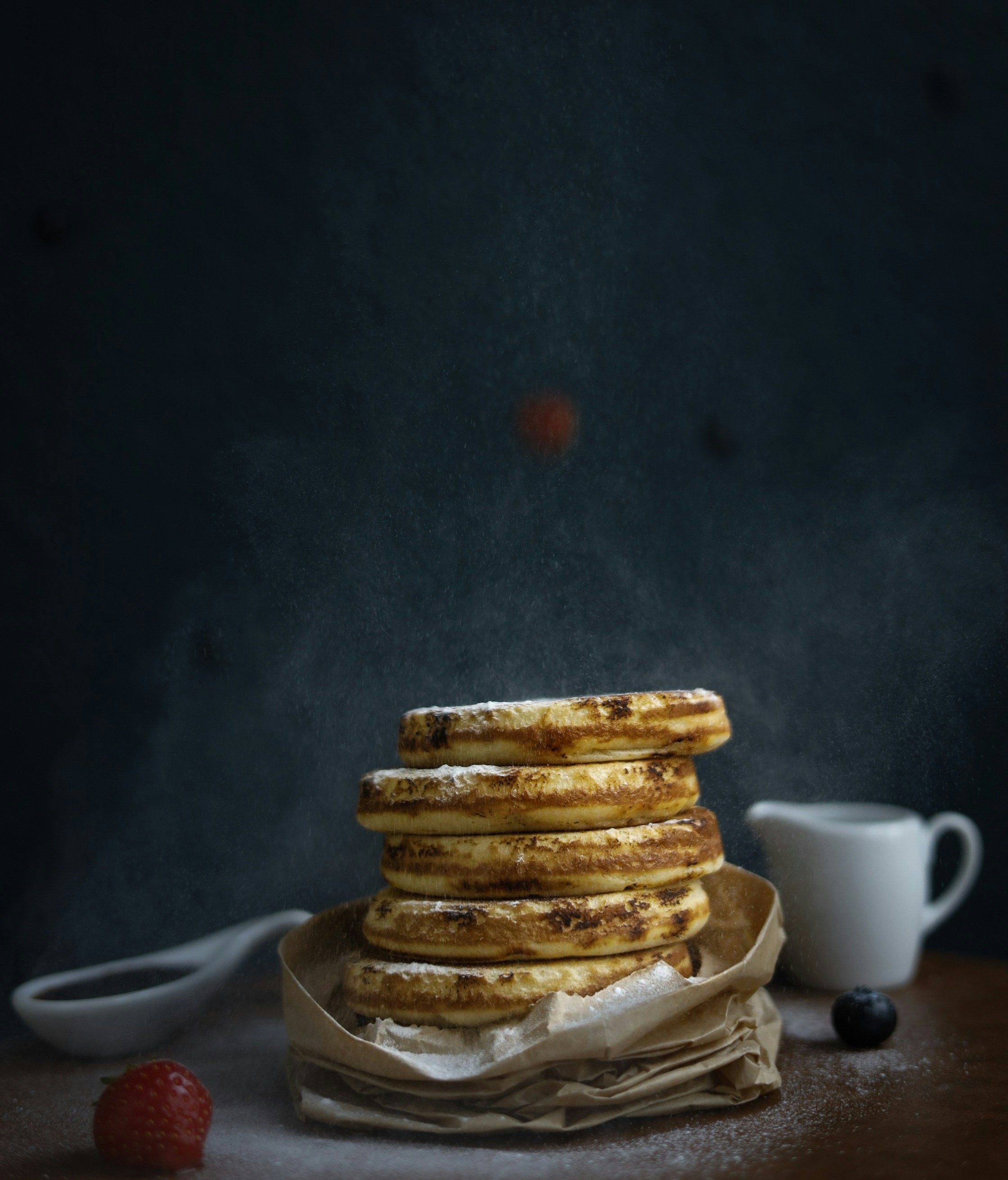 A stack of pancakes sitting on top of a wooden table