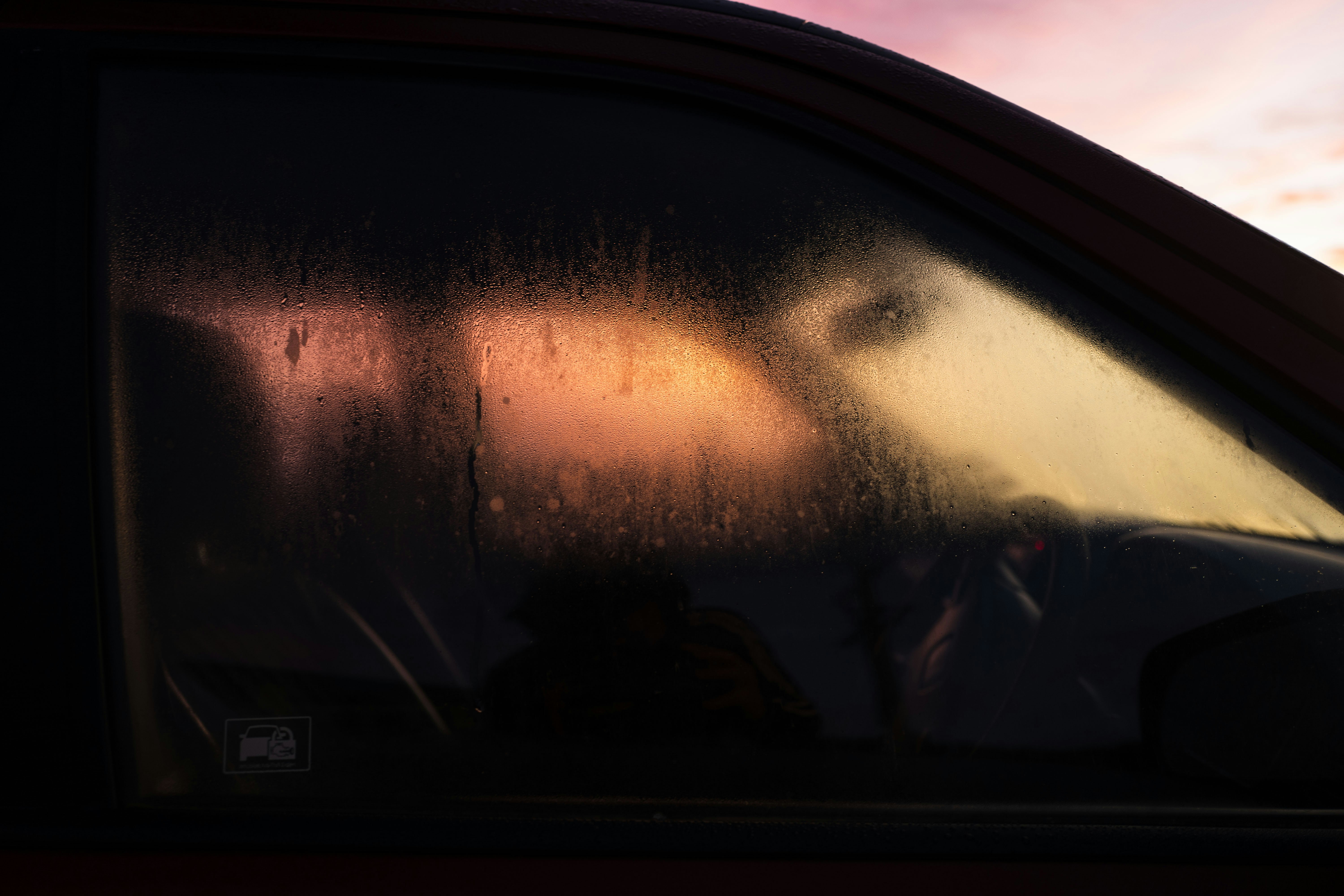 A car with the sun shining through the window