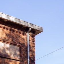 A brick building with a bird perched on top of it