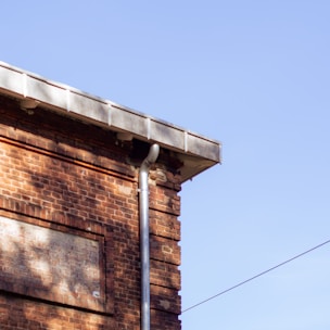 A brick building with a bird perched on top of it