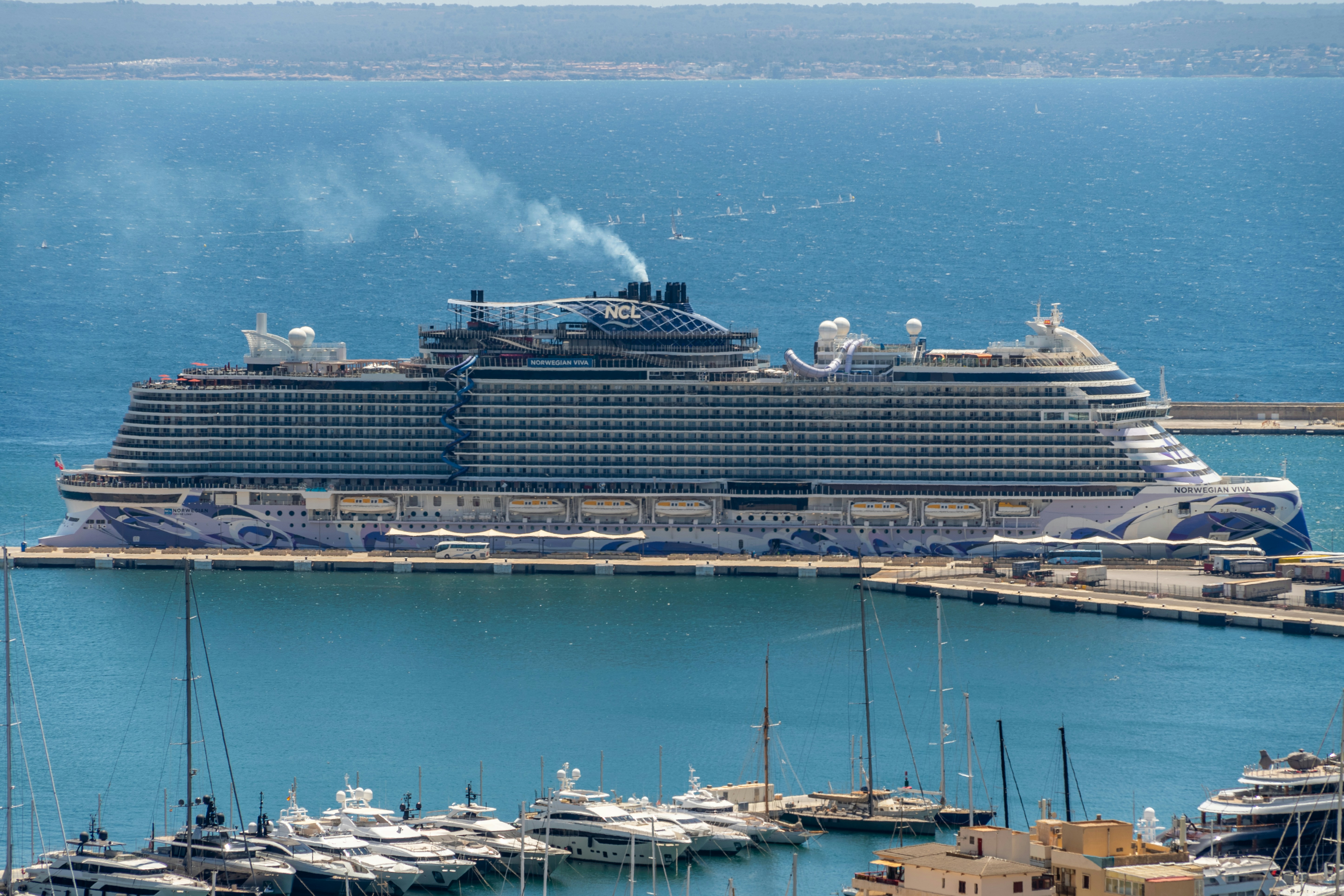 A large cruise ship docked in a harbor, 