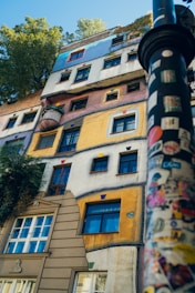 A tall building with lots of windows next to a street light