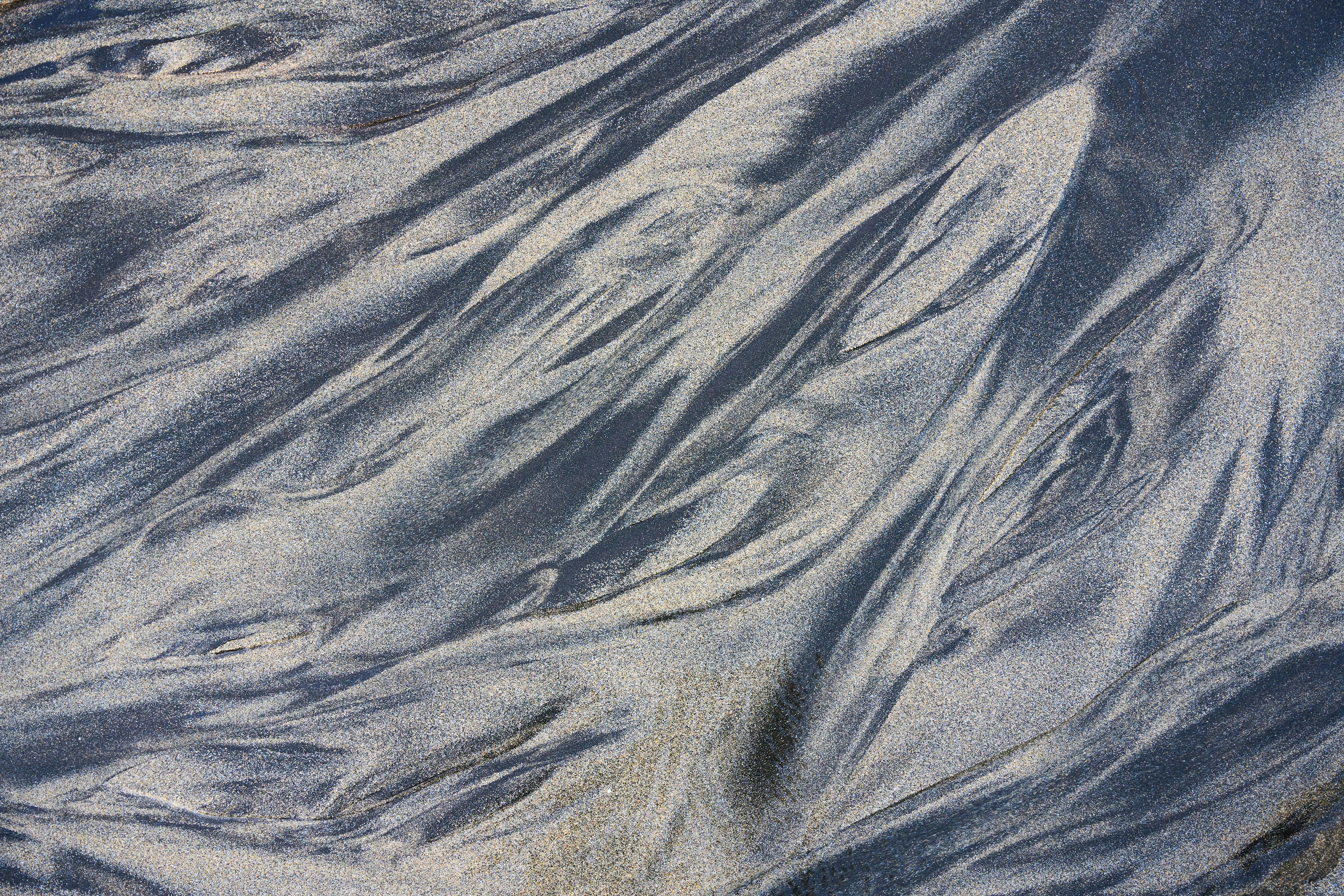 A man riding a snowboard down a snow covered slope