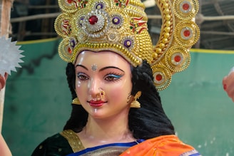 A close up of a statue of a woman holding a fan