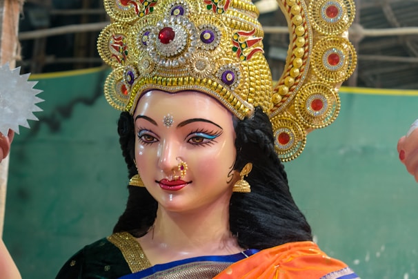A close up of a statue of a woman holding a fan