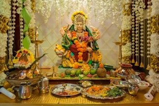 A statue of a person sitting on top of a table