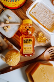 A wooden table topped with lots of honey