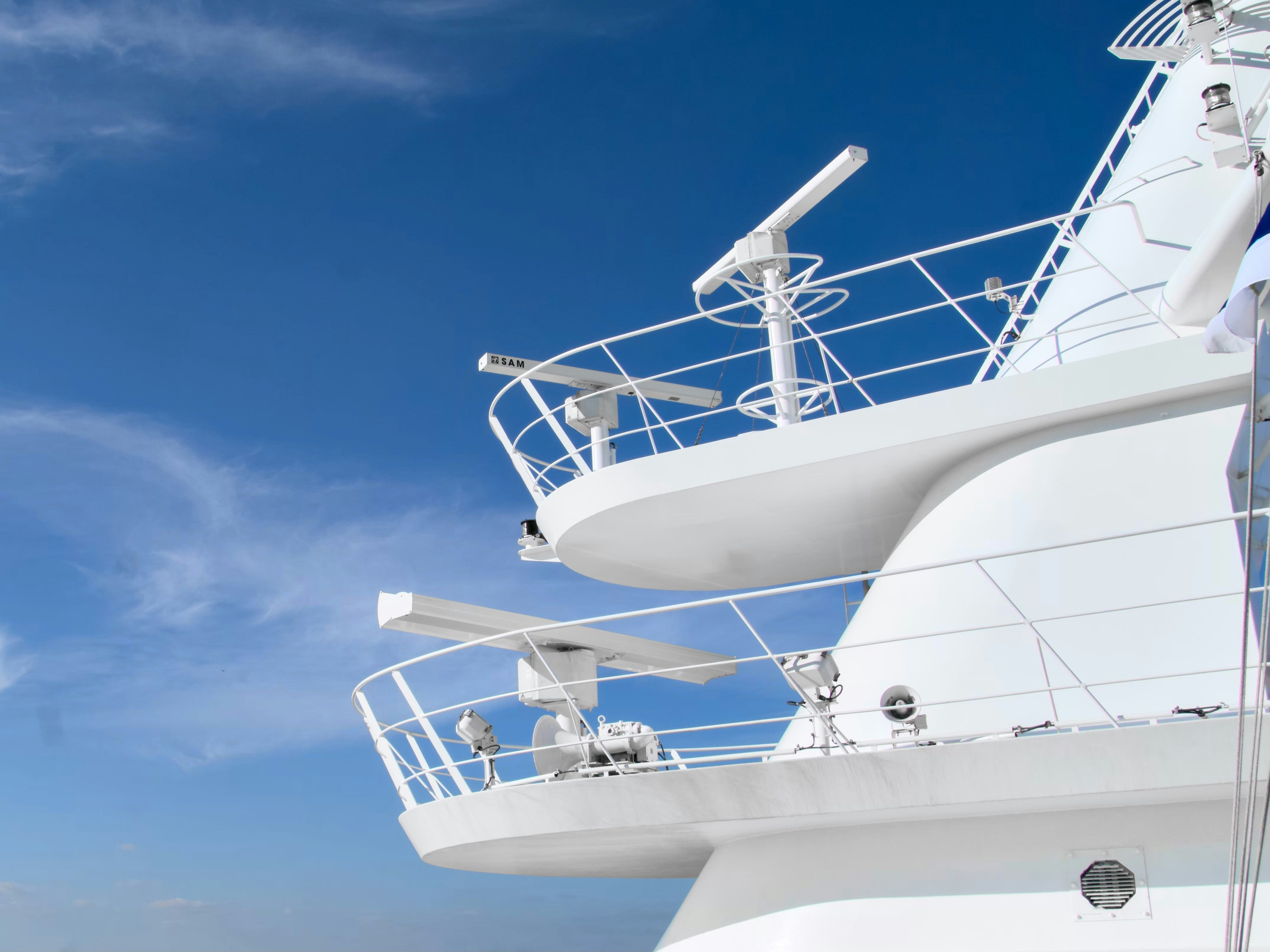 A large white boat floating on top of a body of water