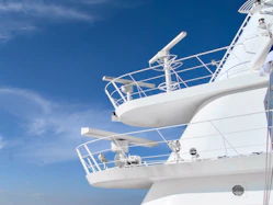 A large white boat floating on top of a body of water