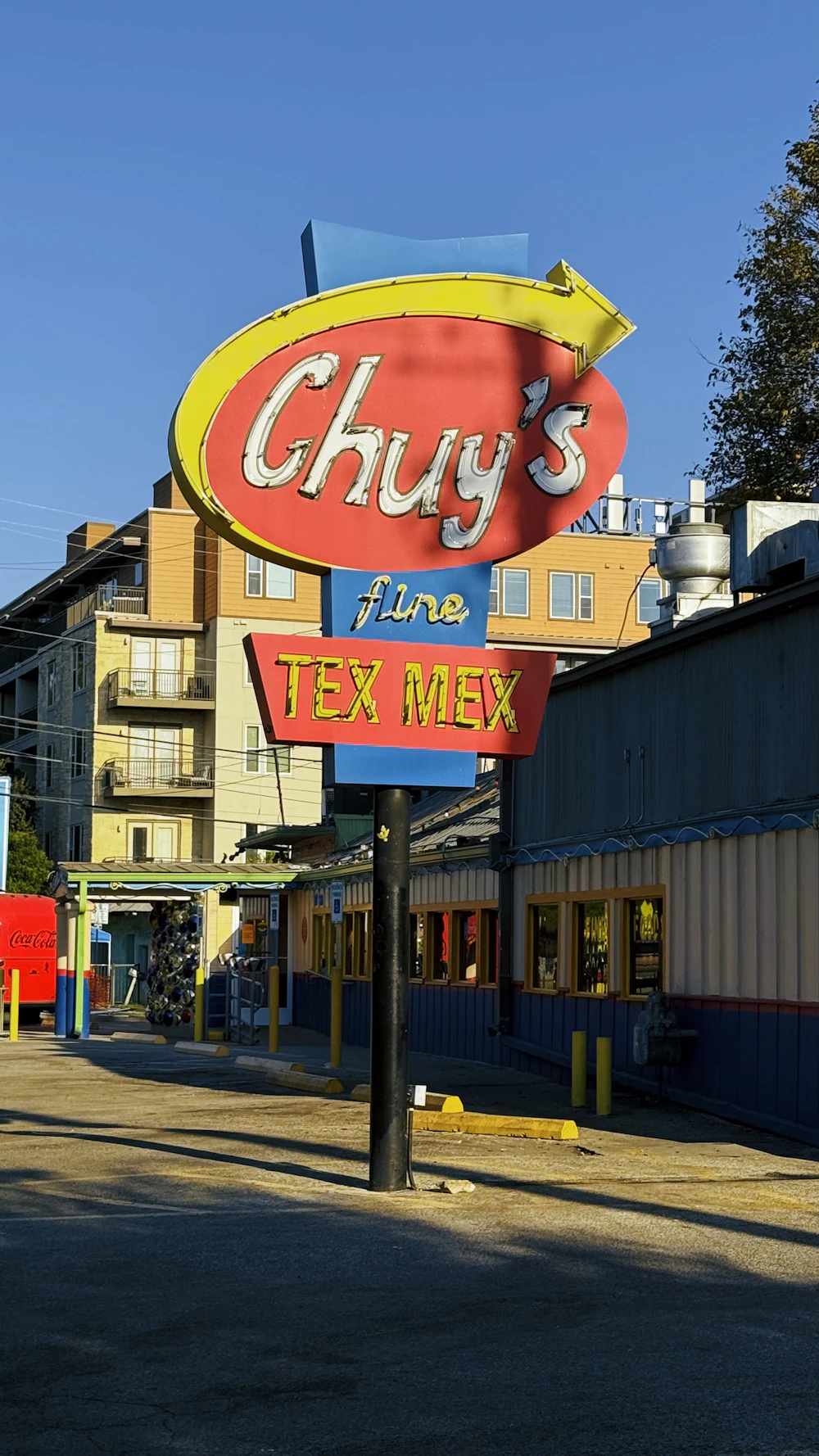 A painted sign hanging outside a Tex Mex restaurant