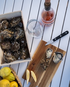 A box of oysters next to a bottle of wine