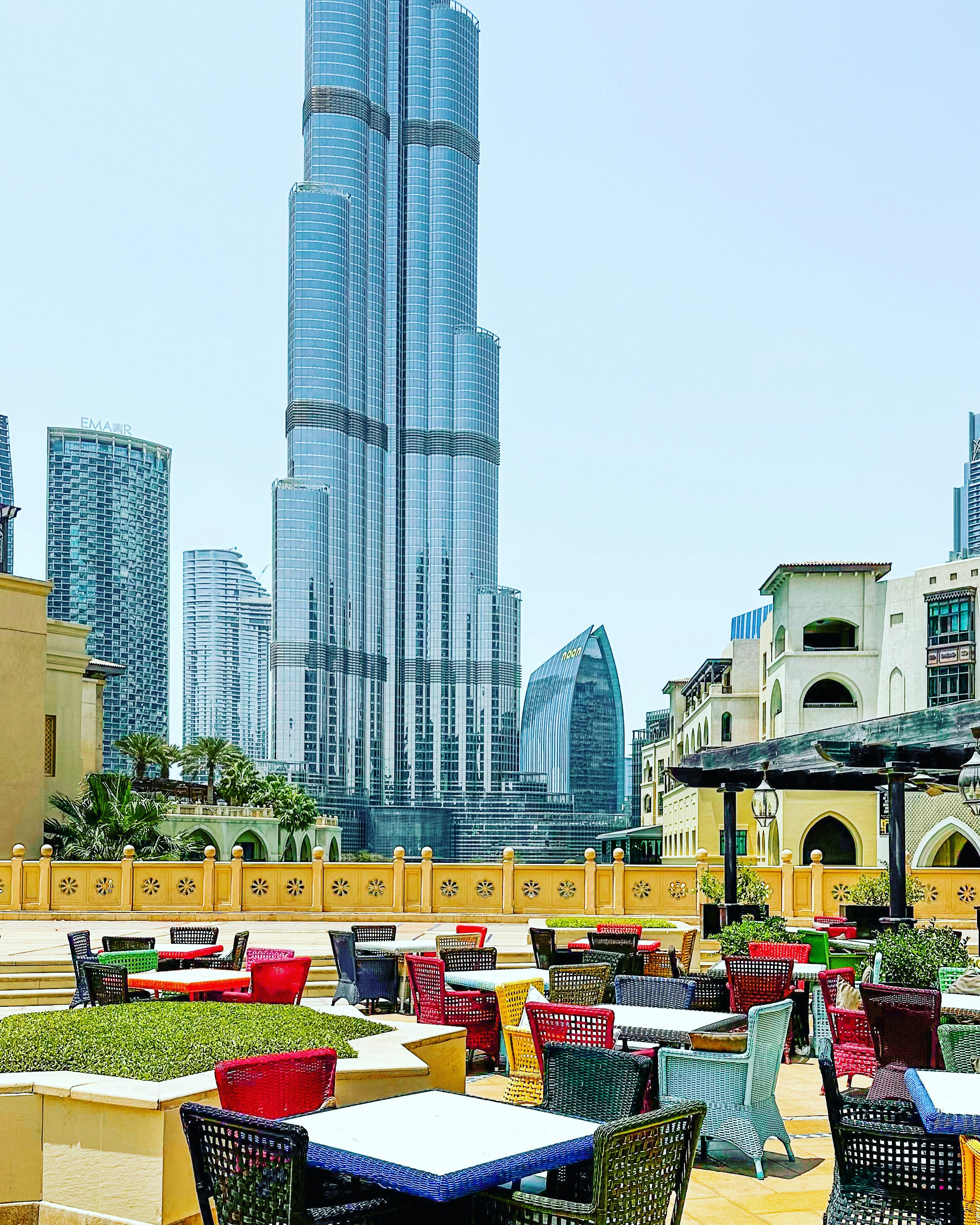 Private terrace with outdoor seating area and unobstructed Burj Khalifa and fountain views at sunset