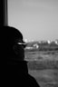 A man looking out a window at an airport