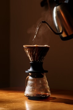 A coffee maker pouring coffee into a cup