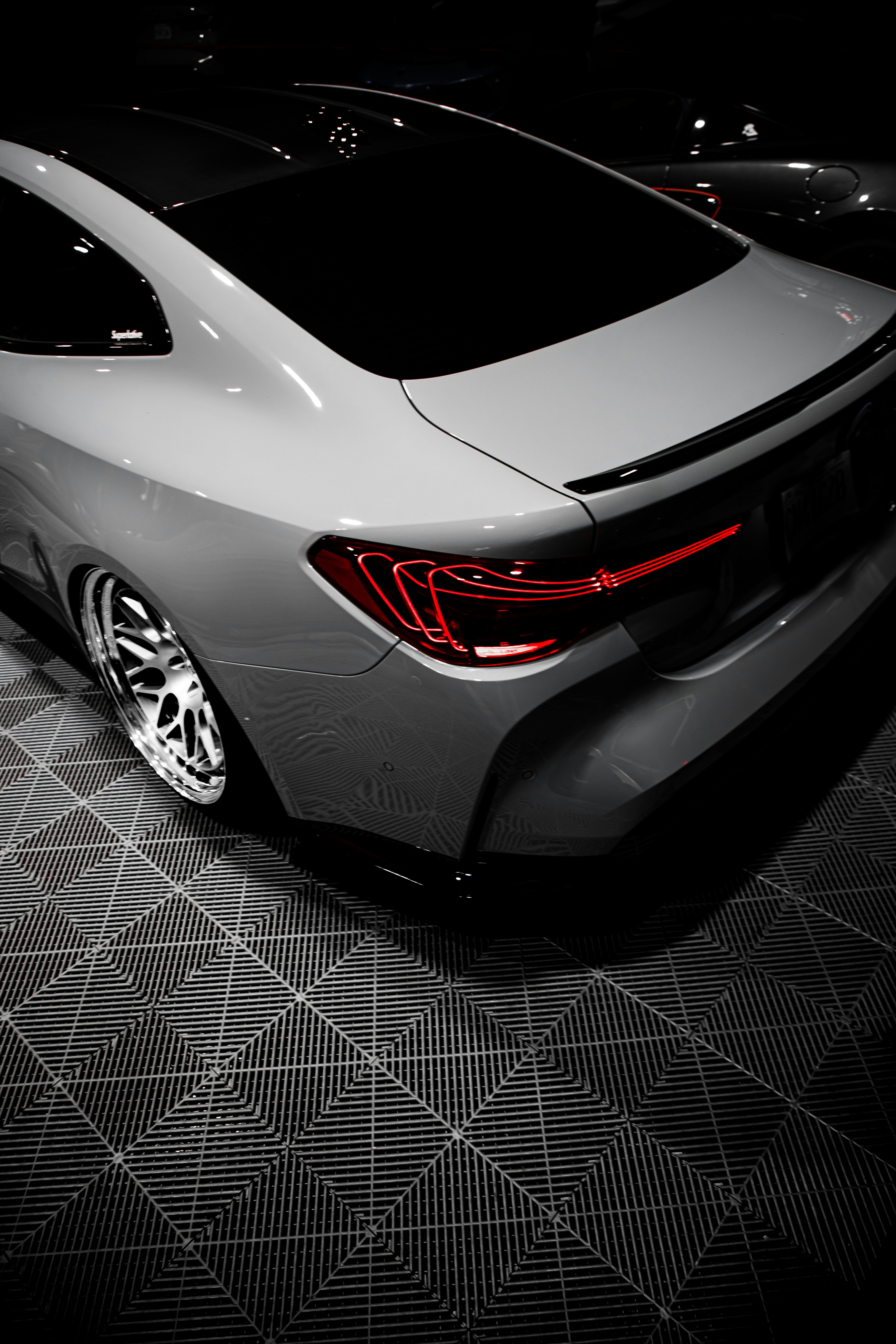 A car is parked in a dark room