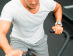 A man on a stationary bike in a gym