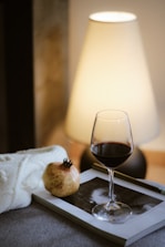 A glass of wine and a book on a table