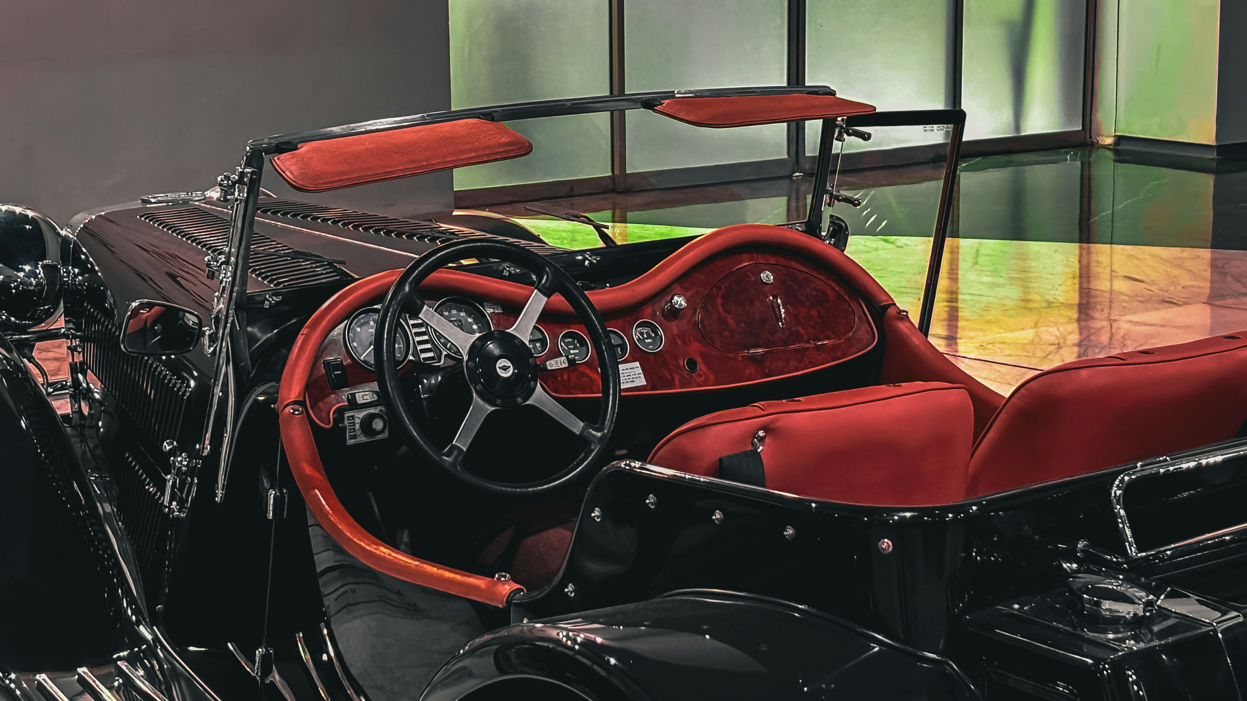 A red and black motorcycle parked in a garage