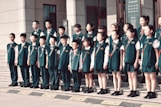 A group of children standing in front of a building