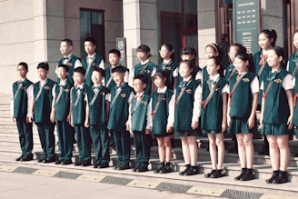 A group of children standing in front of a building