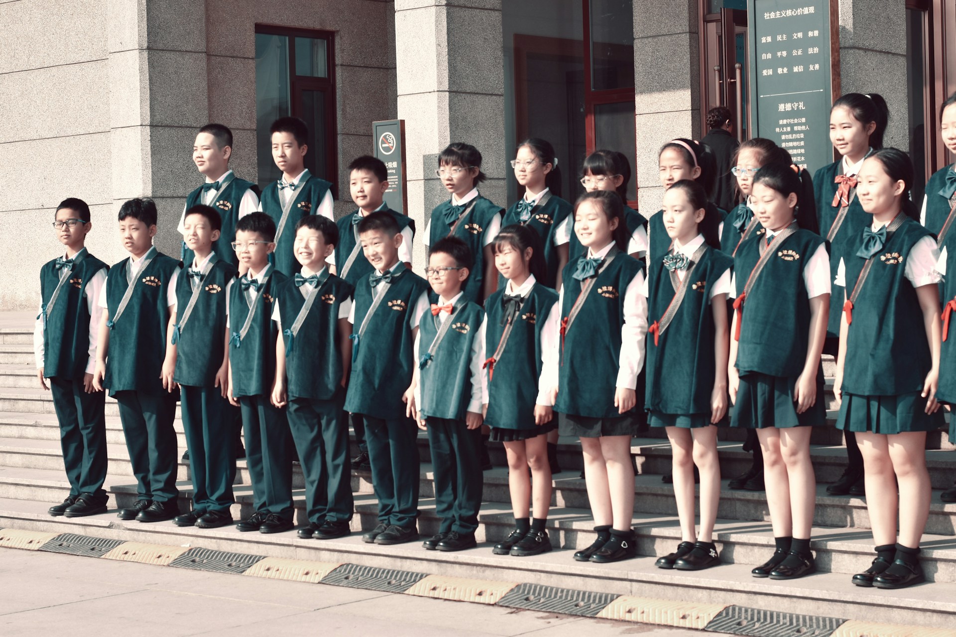 A group of children standing in front of a building
