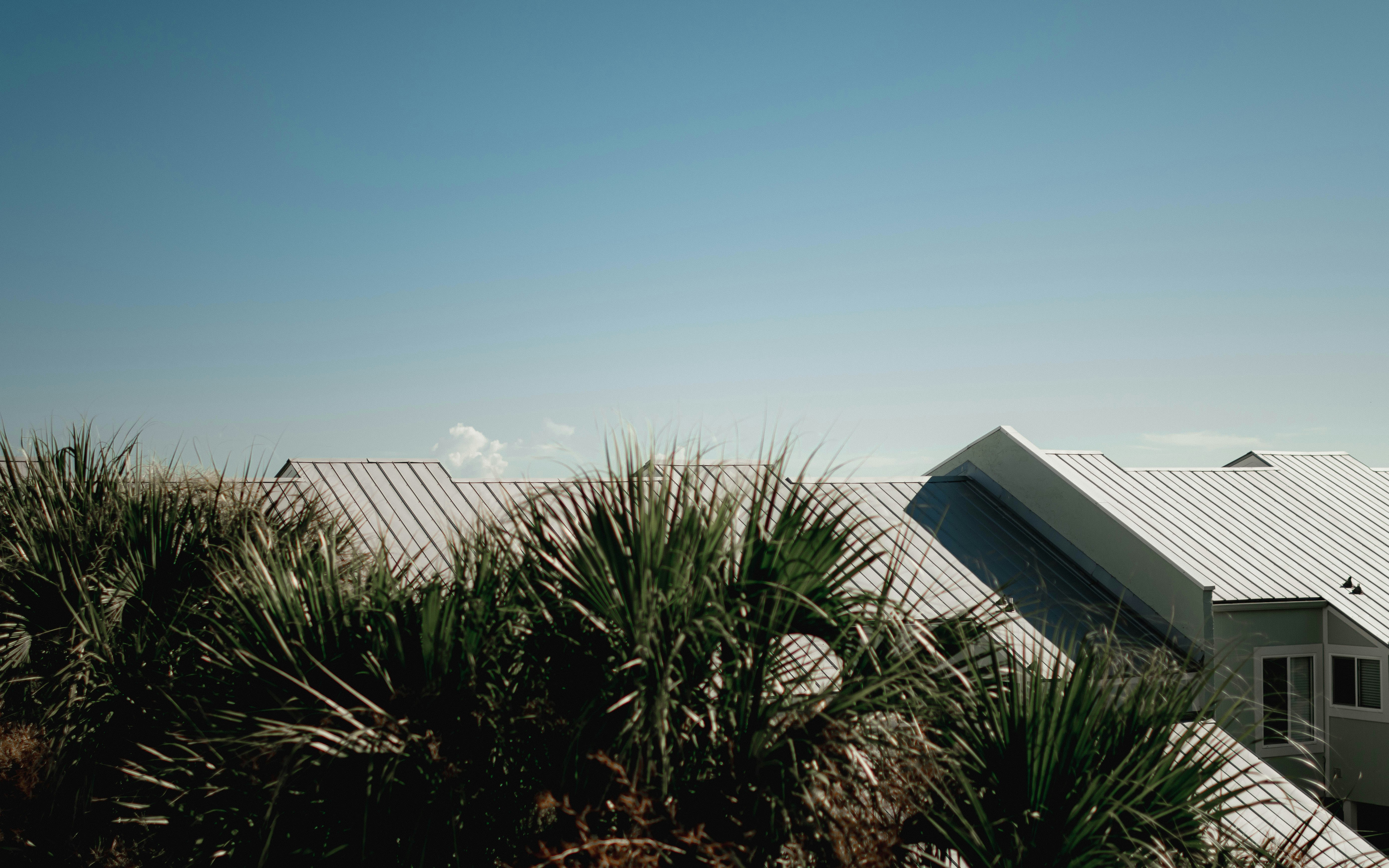 A house with a metal roof and a white roof