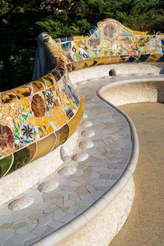 Gaudi's colorful mosaic tile bench winding along the terrace at Park Guell in Barcelona