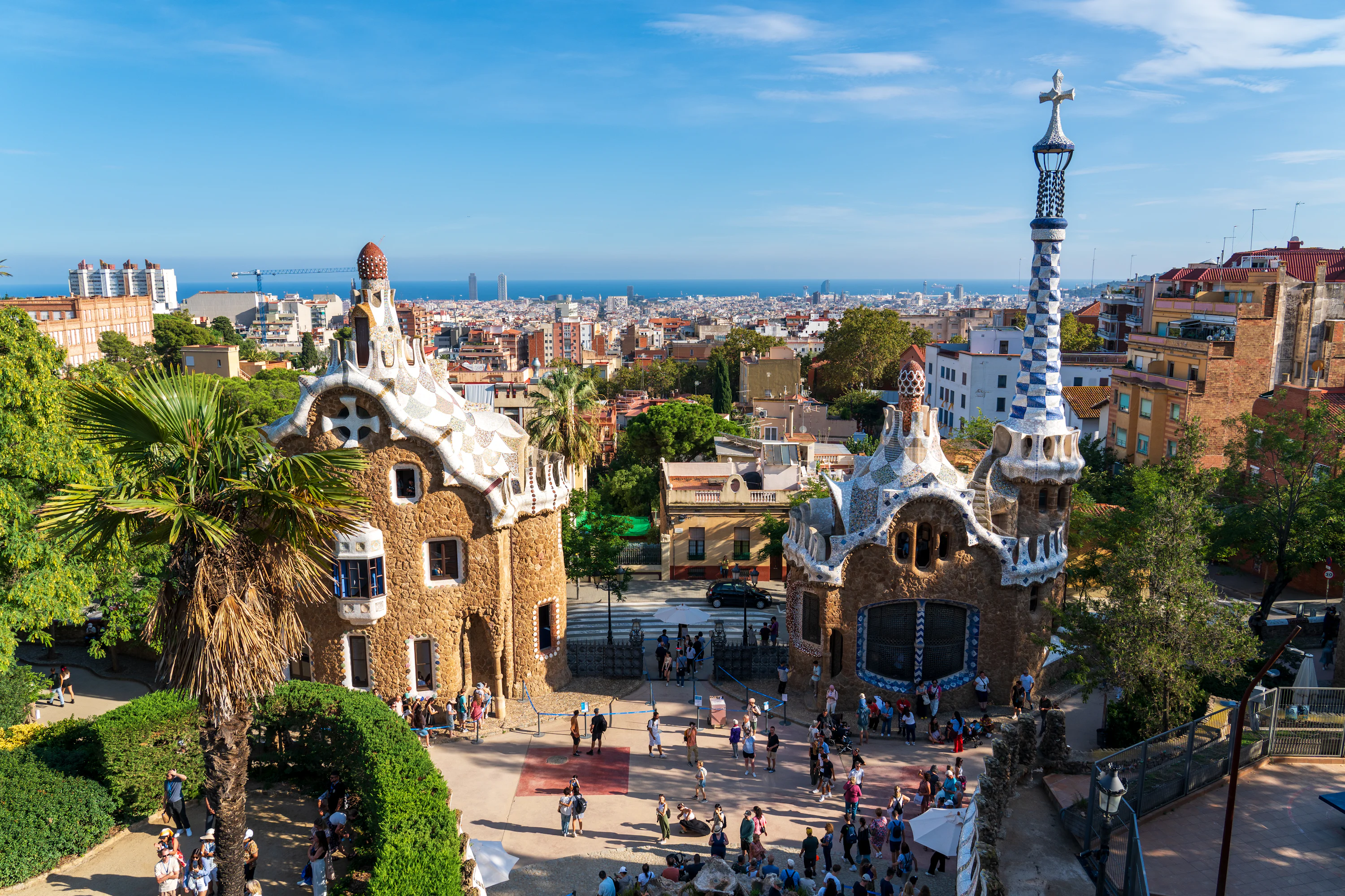 An aerial view of a park with a tower in the background
