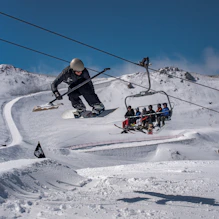 A man flying through the air while riding skis