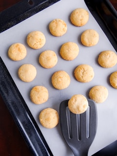 A pan filled with cookies and a spatula