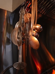 A bunch of pots and pans hanging from a wall