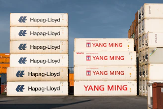 A stack of shipping boxes sitting on top of a parking lot