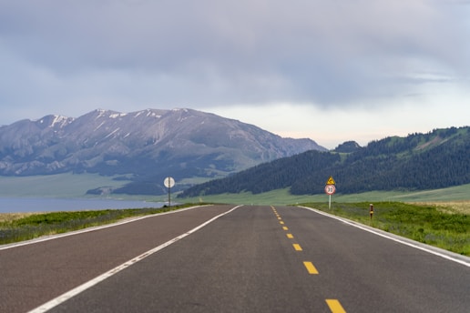 An empty road with mountains in the background
