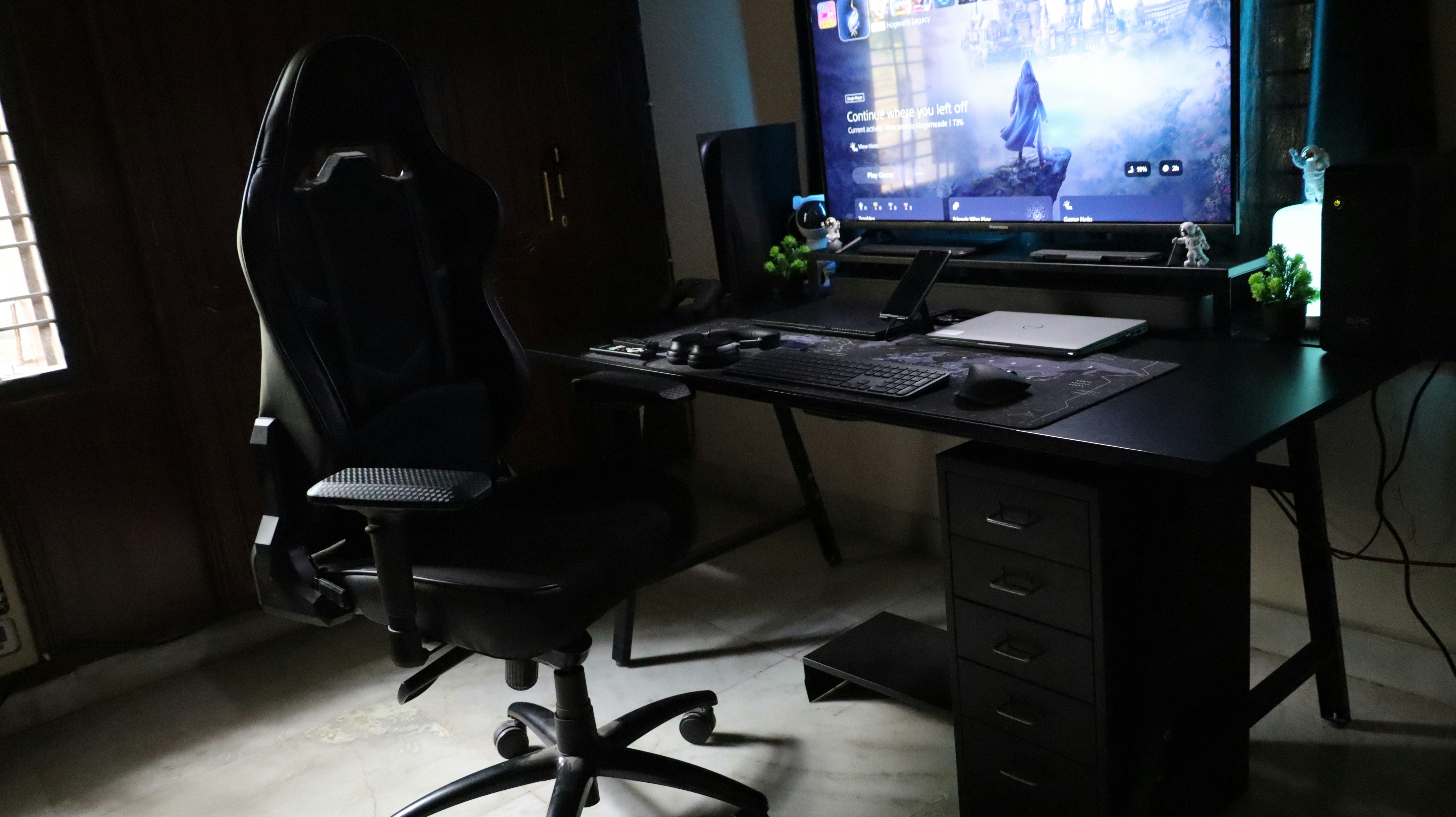 A computer desk with a monitor and a chair