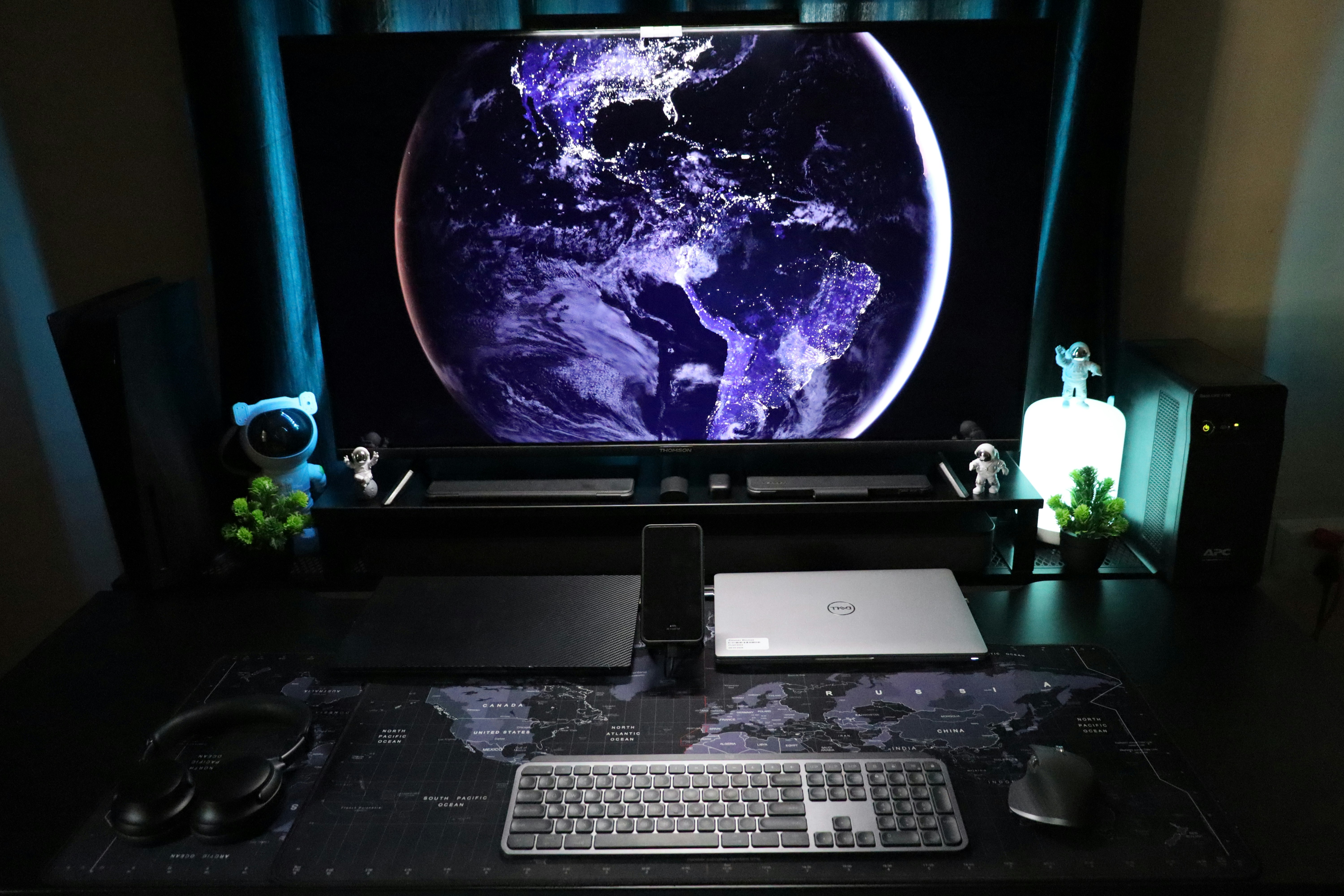 A computer desk with a monitor and keyboard