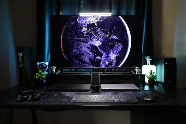A desk with a monitor and keyboard on it