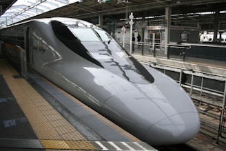 A high speed bullet train pulling into a train station