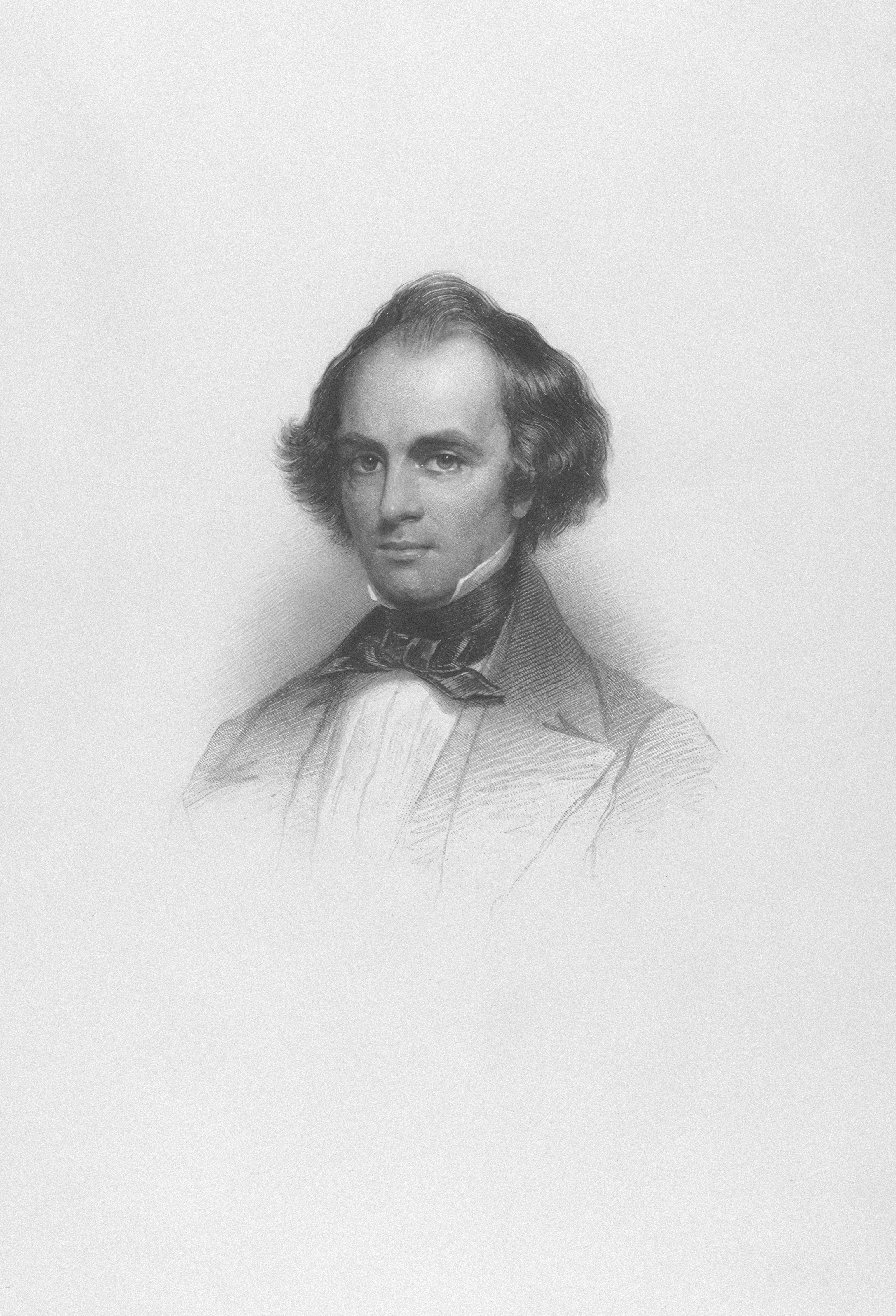 Un homme aux cheveux coiffés et nœud papyon.