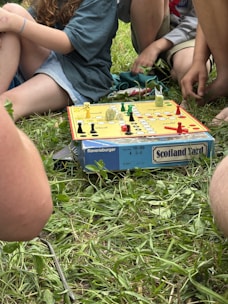 A group of people sitting around a board game