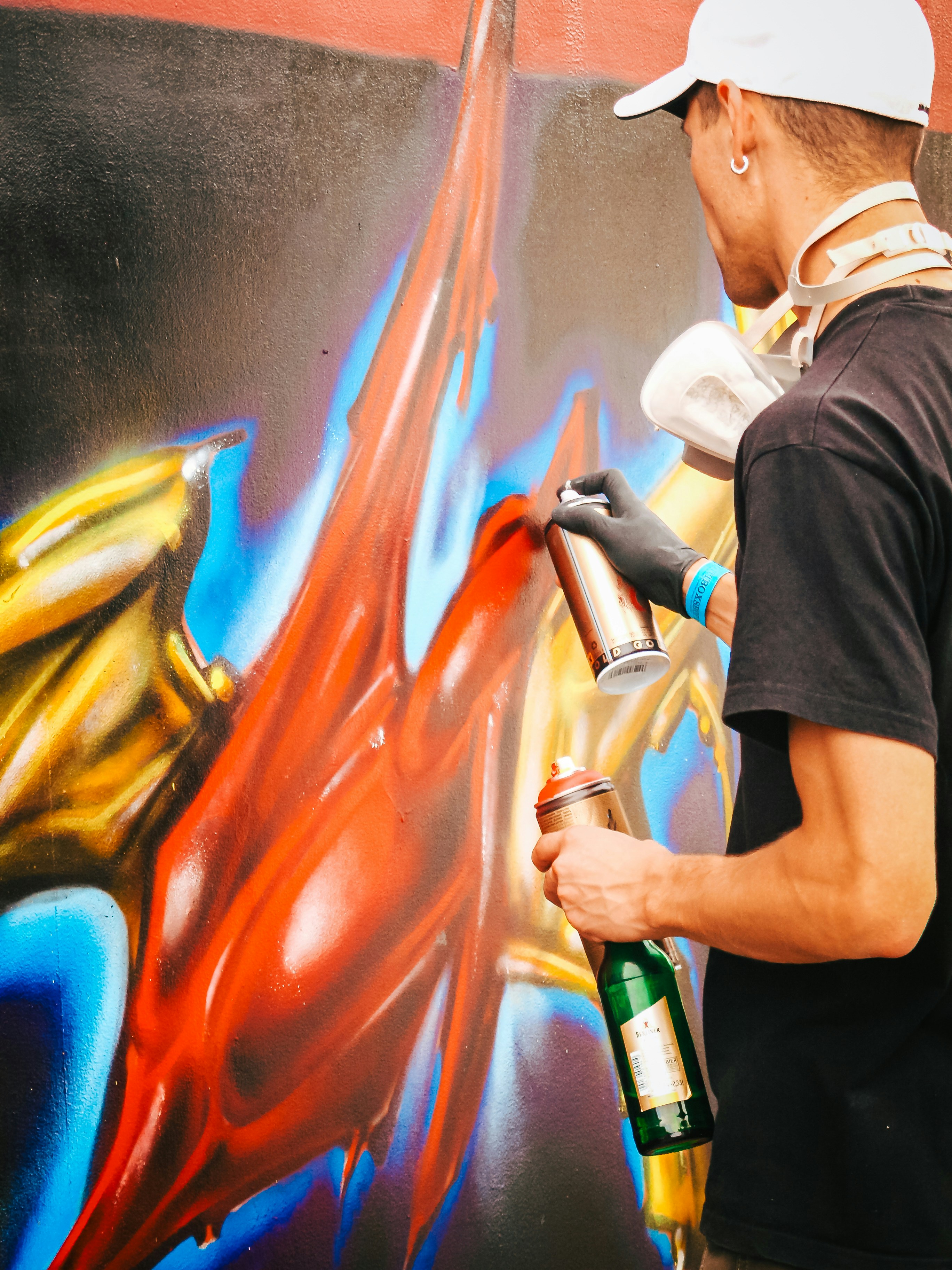 A man painting a wall with a spray gun