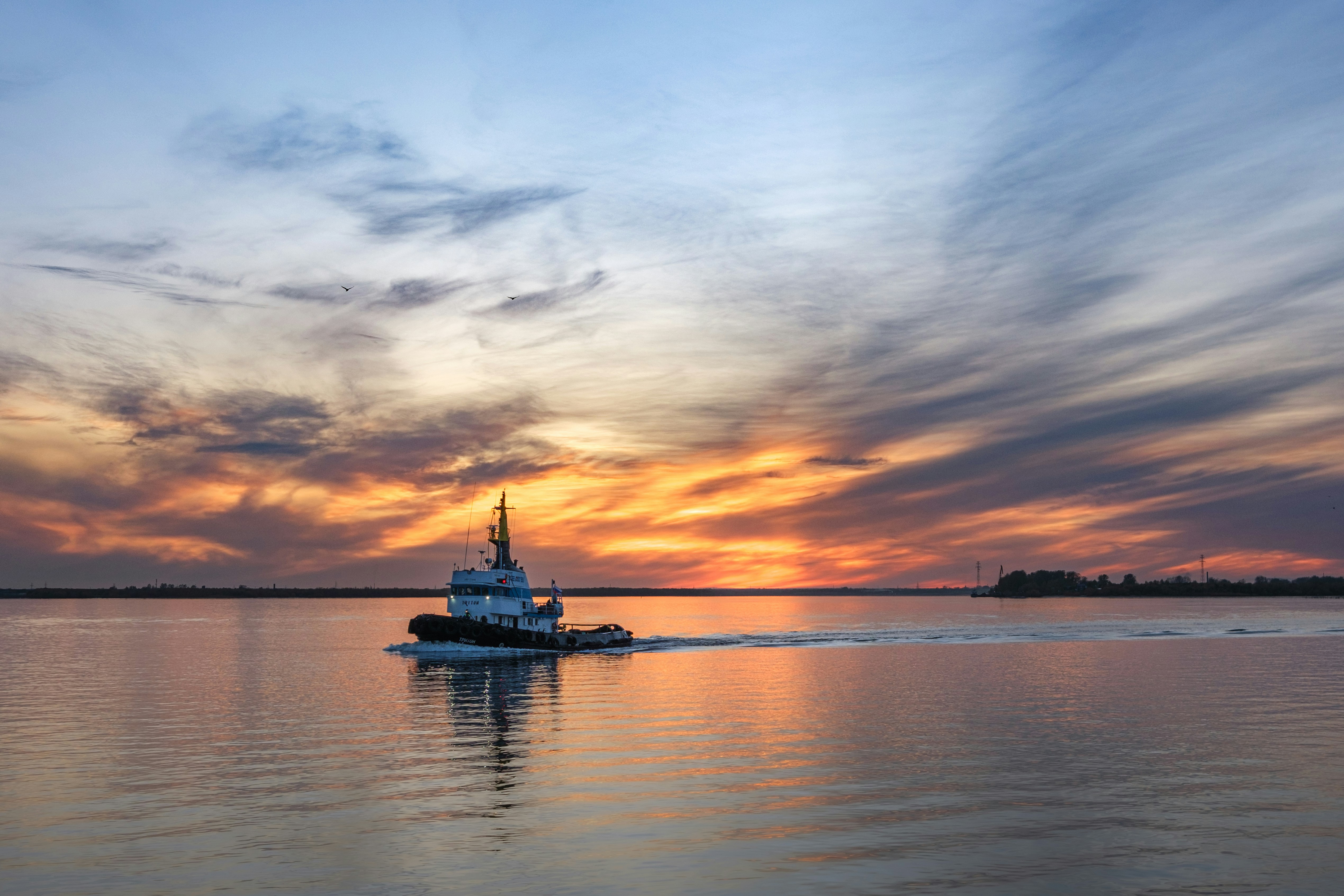 A small boat traveling across a large body of water