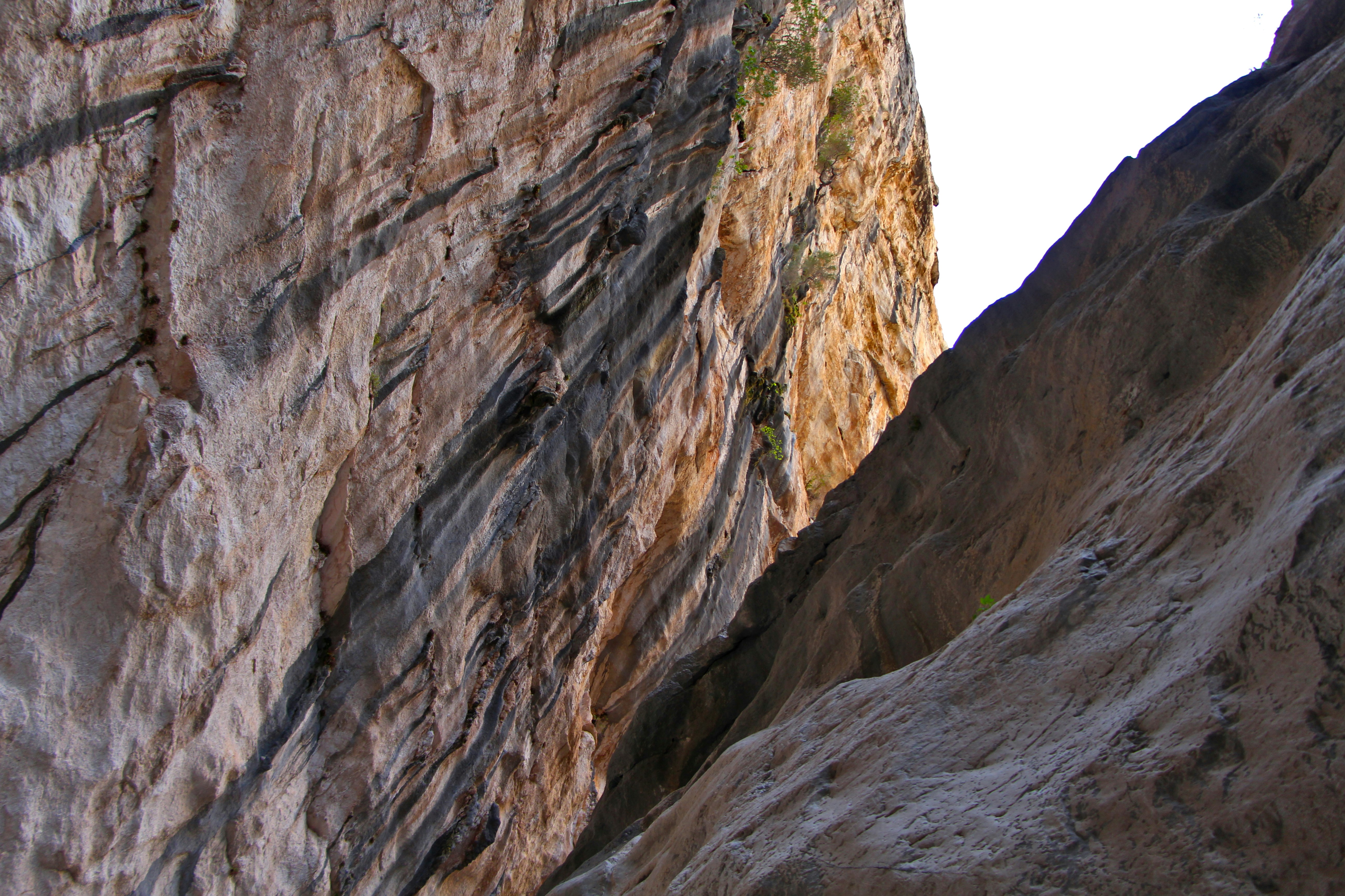 A man climbing up the side of a mountain