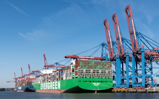 A large green and blue container ship in the water