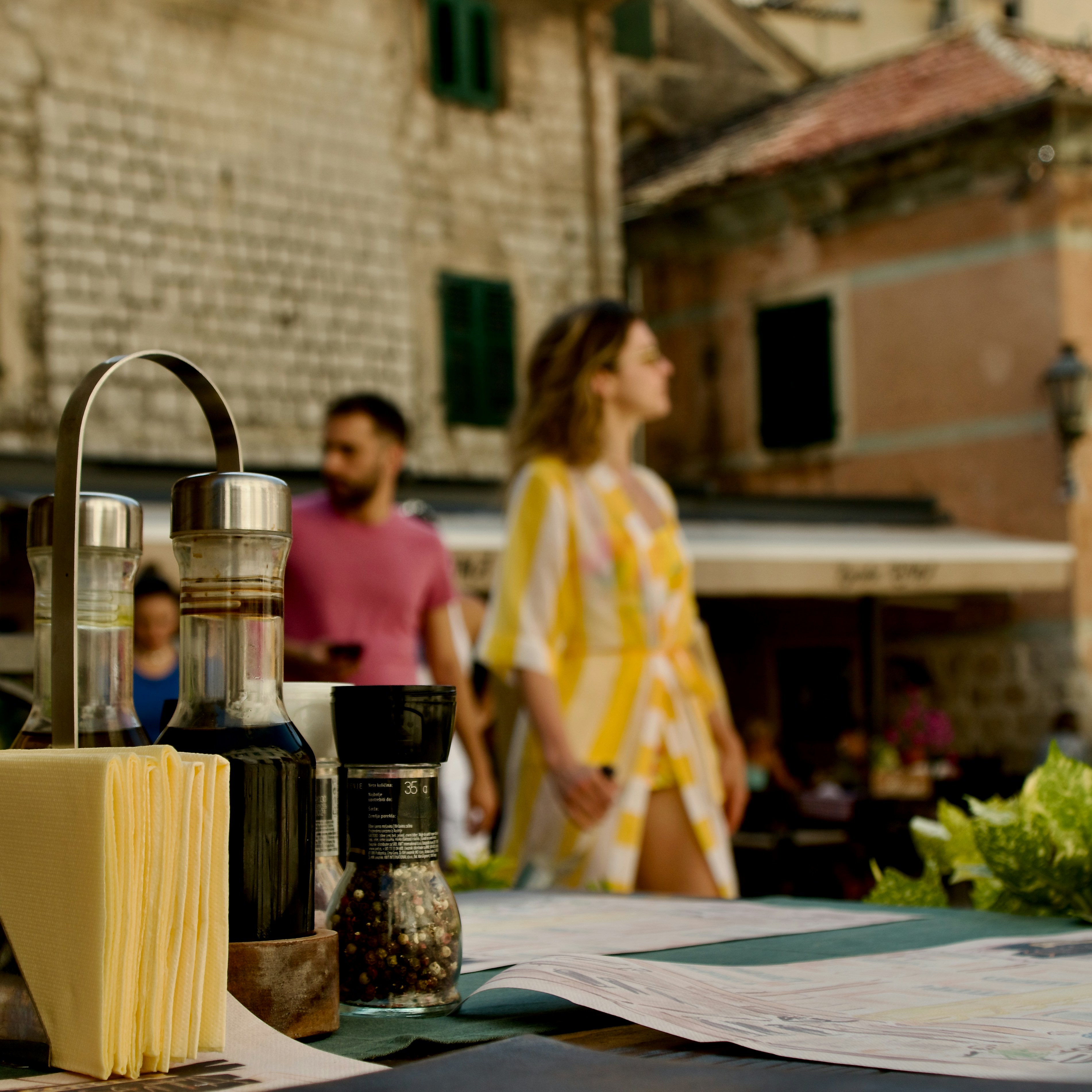 A table topped with cheese and bottles of wine