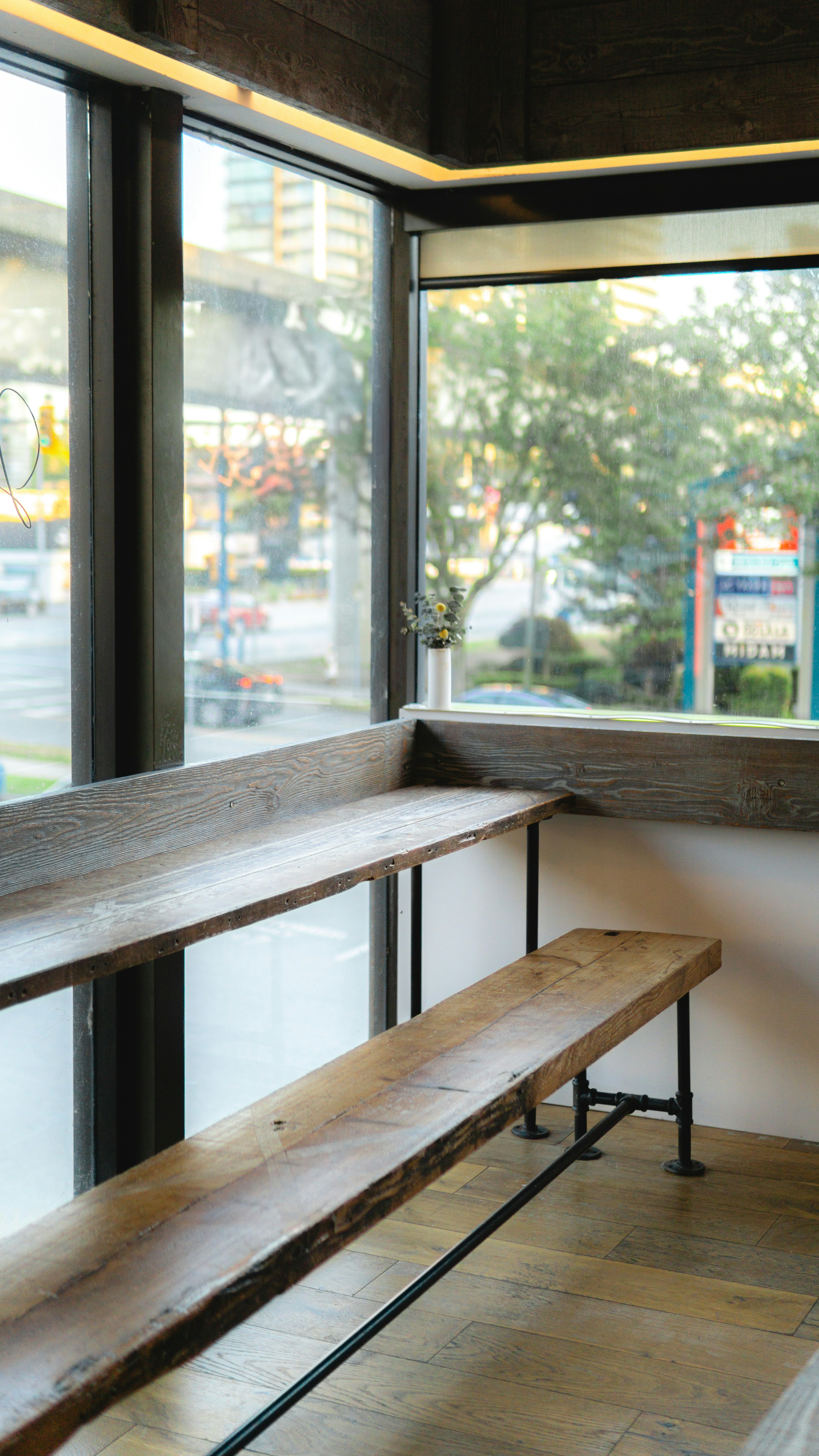 A wooden bench sitting in front of a window