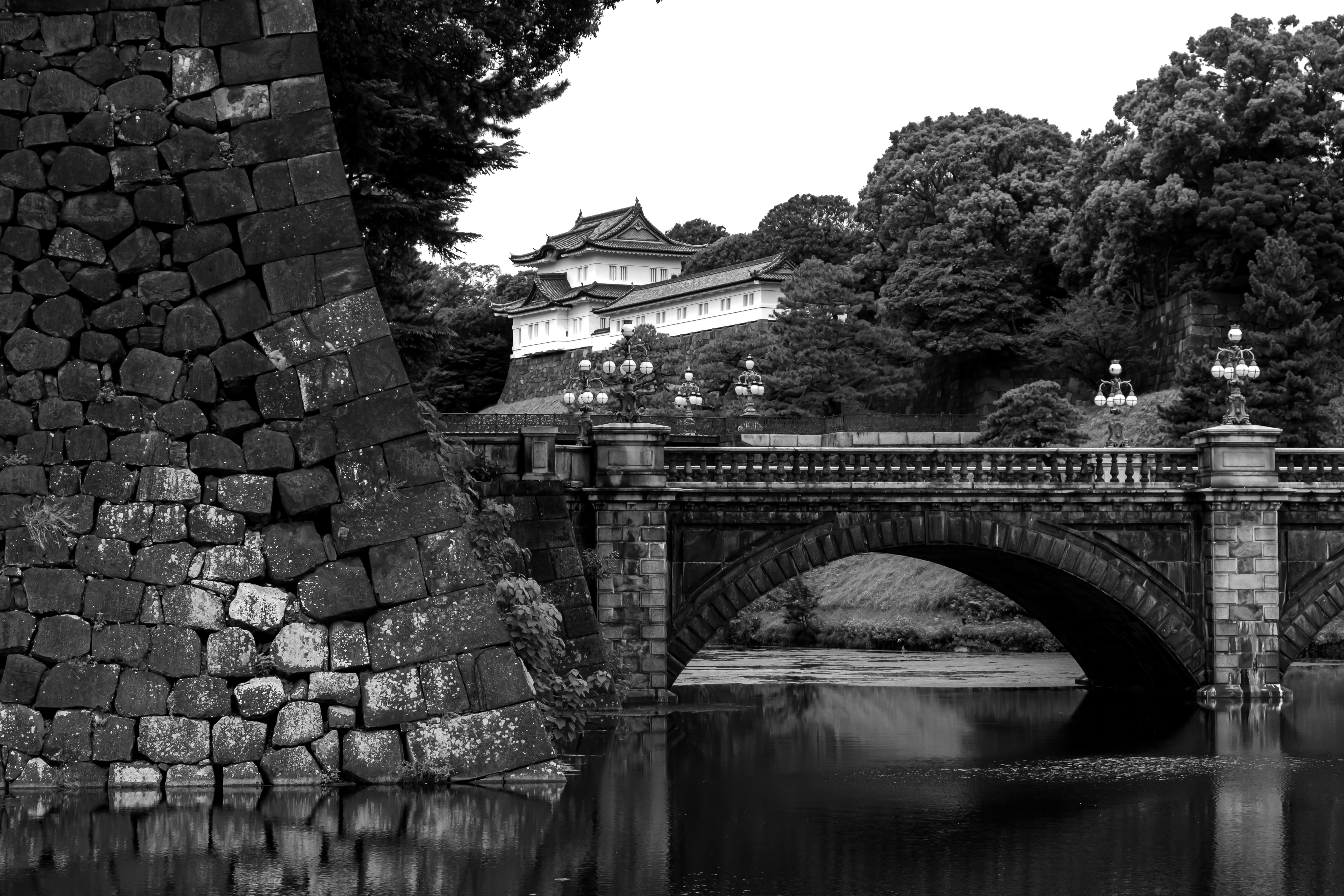 A black and white photo of a bridge over a body of water