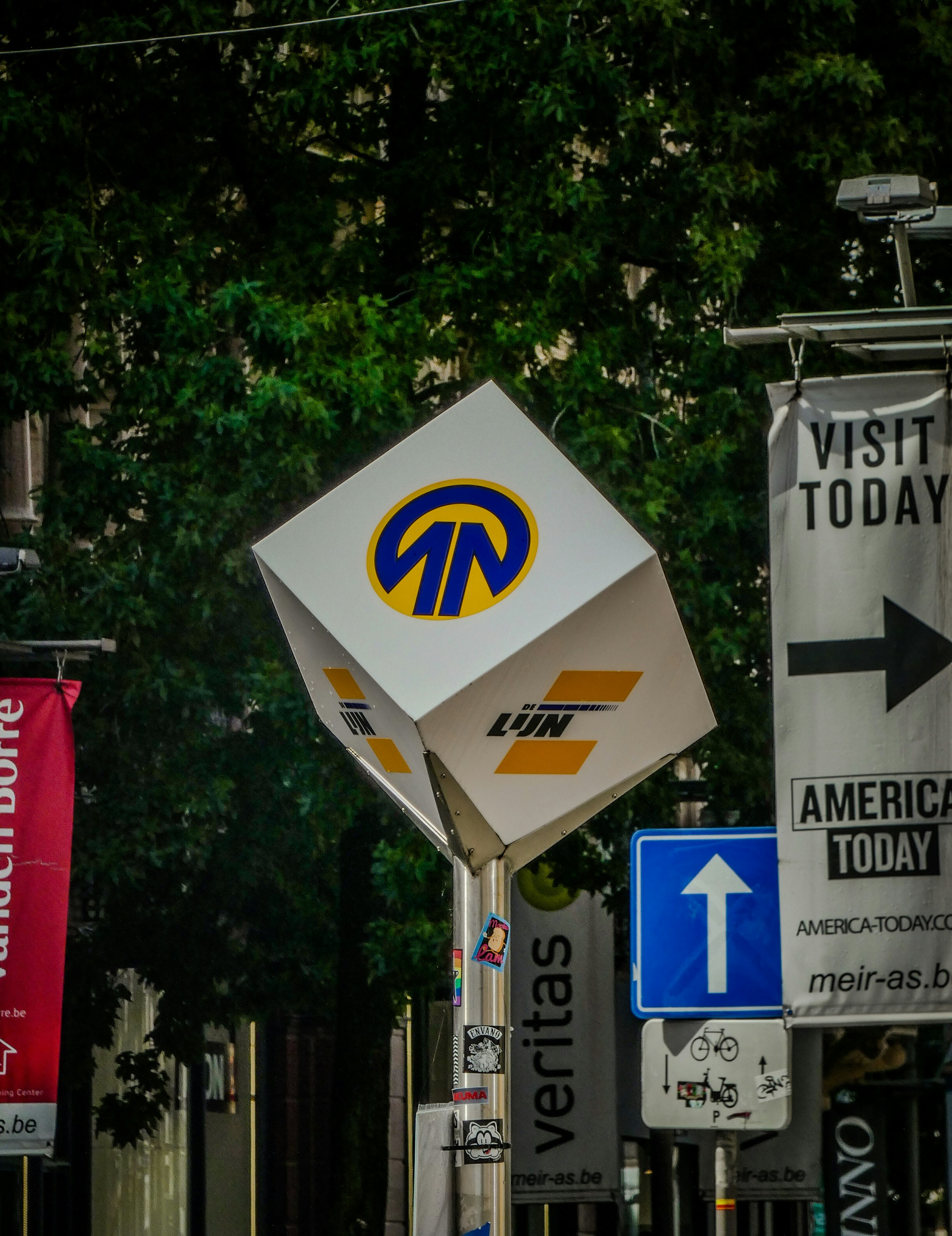 A bunch of signs that are on a pole